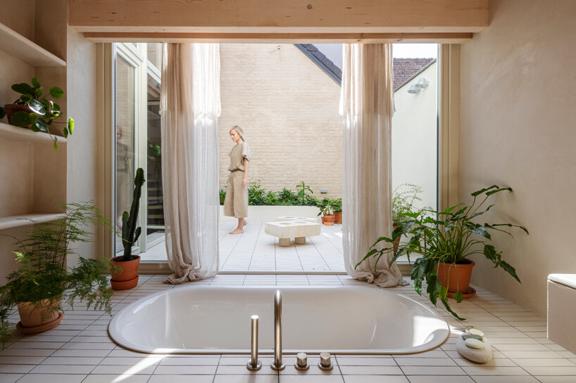 hé! transforms industrial building into house with timber roof extension in brussels