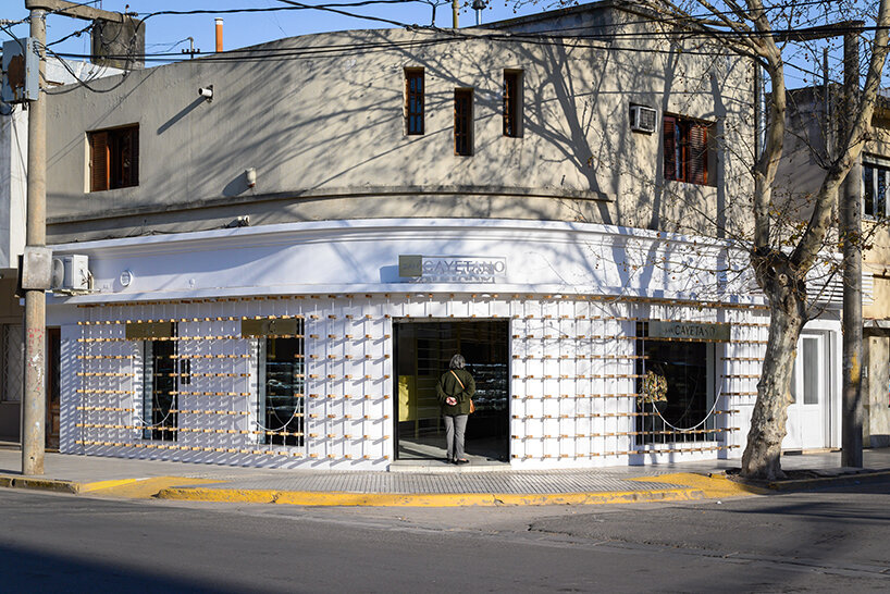 EFEEME arquitectos uplifts bakery façade in argentina with smooth iron and wooden props