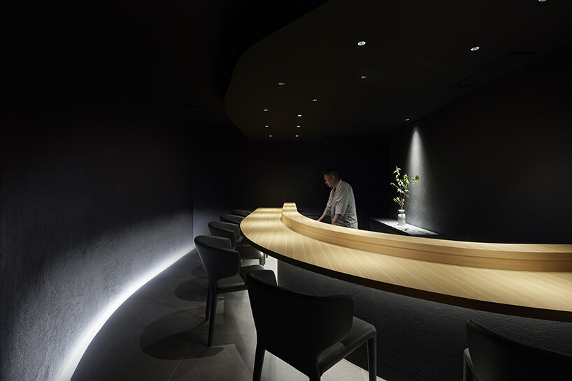 Black ink walls and dim lighting cover this members-only sushi restaurant in Tokyo