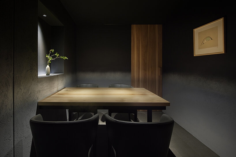 Black ink walls and dim lighting cover this members-only sushi restaurant in Tokyo