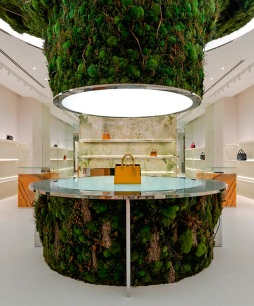 abstract tree installation sprouts from the floor to display premium leather goods