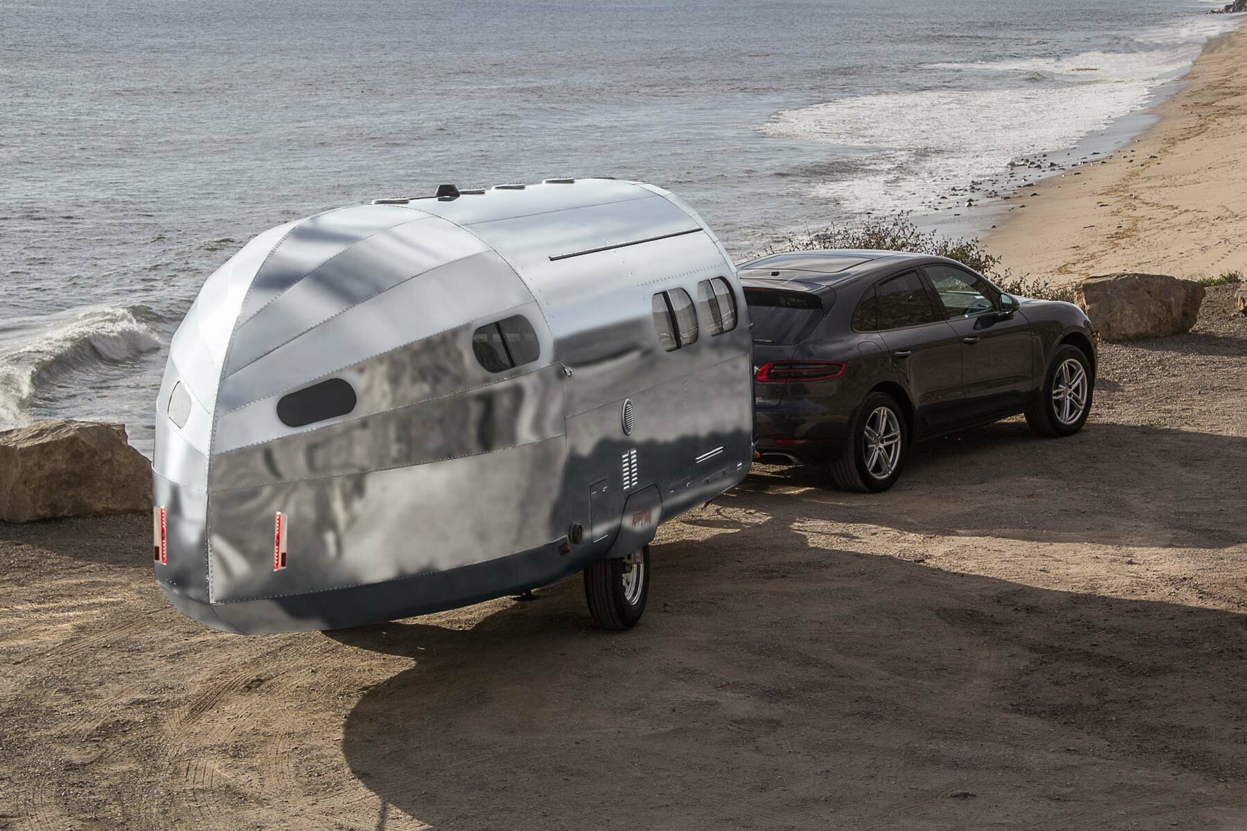 bowlus clads bullet-shaped travel trailer in silver armor