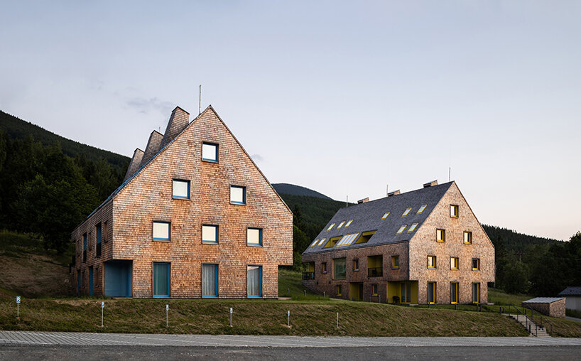 a mosaic of colored voids & glass adorns new apartment buildings in the czechian mountains