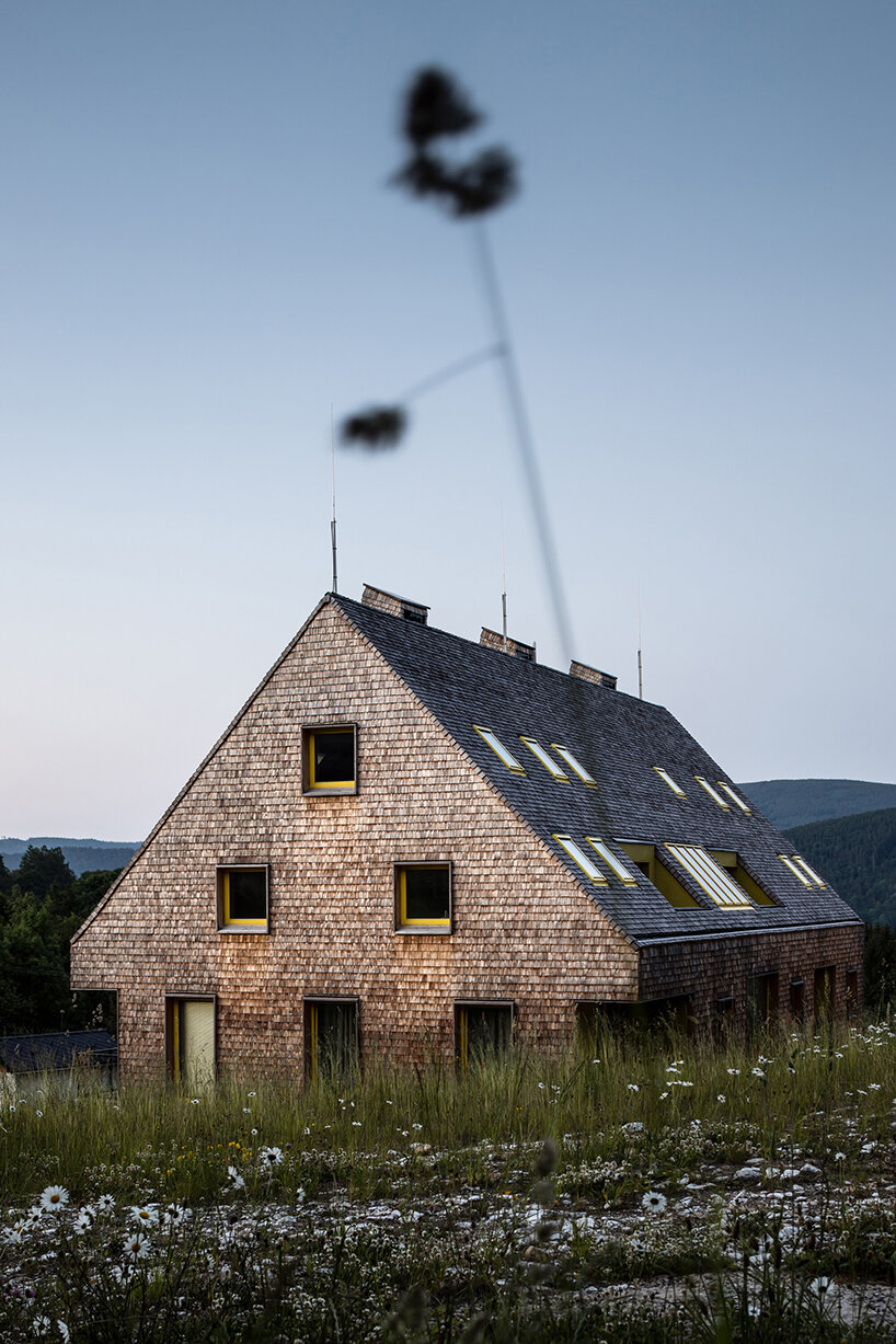 a mosaic of colored voids & glass adorns new apartment buildings in the czechian mountains