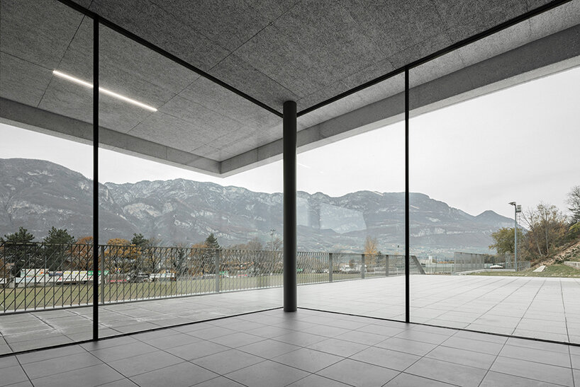 modusarchitects' long concrete sports center divides italian mountain