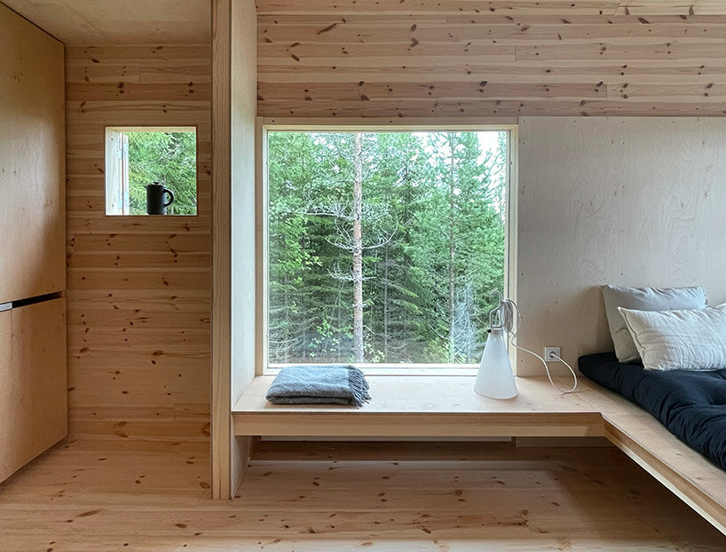 wooden cabin on stilts is perched on sweden's mountainous scenery