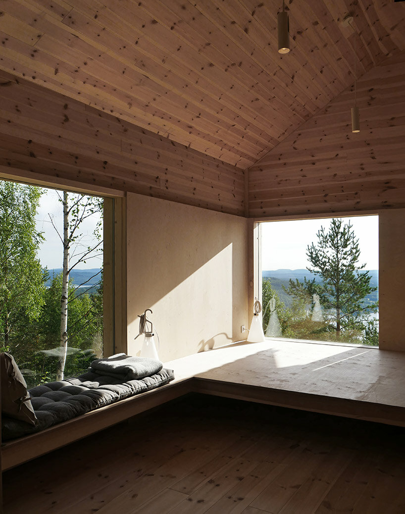 wooden cabin on stilts is perched on mountainous scenery in sweden