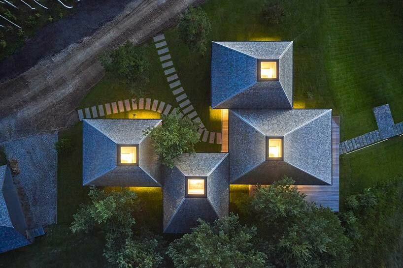 in the picturesque hills of lithuania, a cluster of guest houses by HEIMA gazes skywards