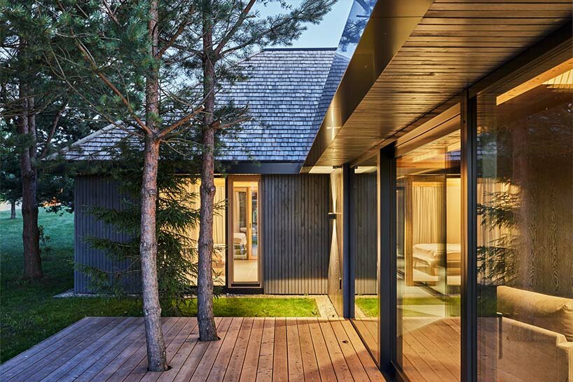 in the picturesque hills of lithuania, a cluster of guest houses by HEIMA gazes skywards