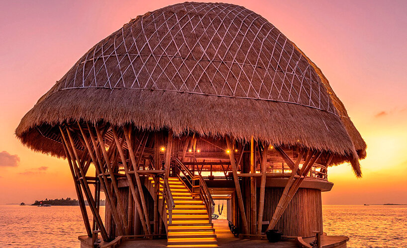 weaved bamboo roofs enclose pavilions for wellness resort in the maldives