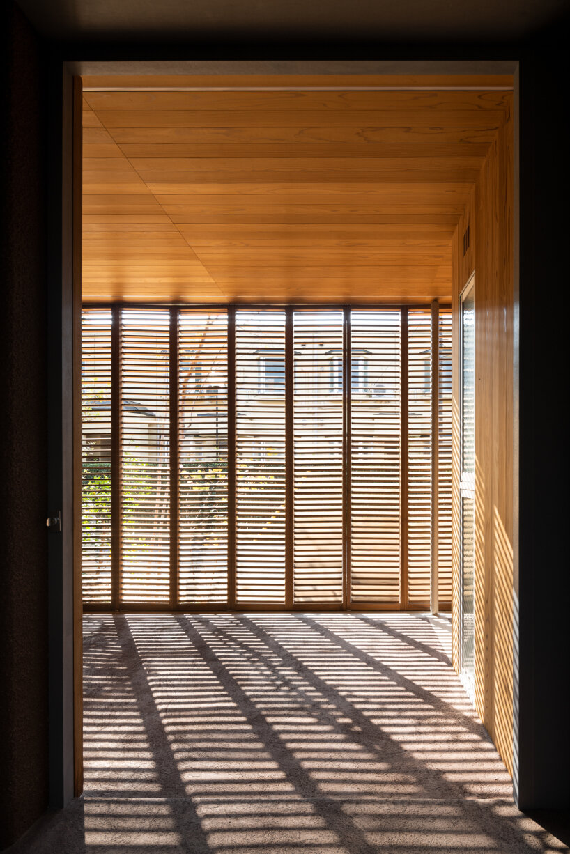 house in nakamachi plays with sunlight through reversible and sliding wooden shutters
