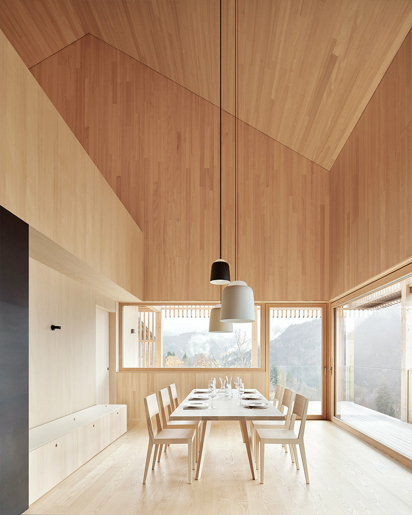 slender wooden slabs enclose permeable facade for 'multigenerational house' in rural austria