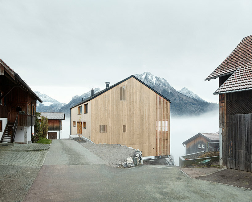 slender wooden slabs enclose permeable facade for 'multigenerational house' in austria