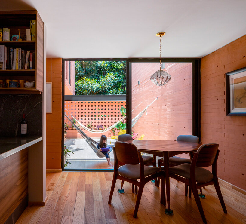 orange-tinted concrete blocks subtly stack residential complex in mexico