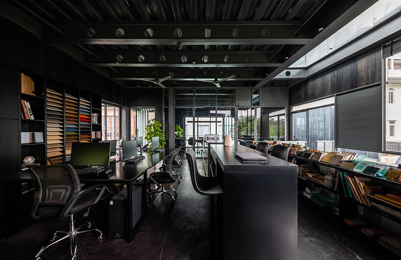 seemingly built from scraps, aaaaaa's office on stilts embraces the vietnamese climate