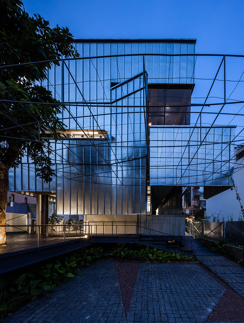 seemingly built from scraps, aaaaaa's office on stilts embraces the vietnamese climate