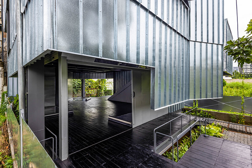 seemingly built from scraps, aaaaaa's office on stilts embraces the vietnamese climate
