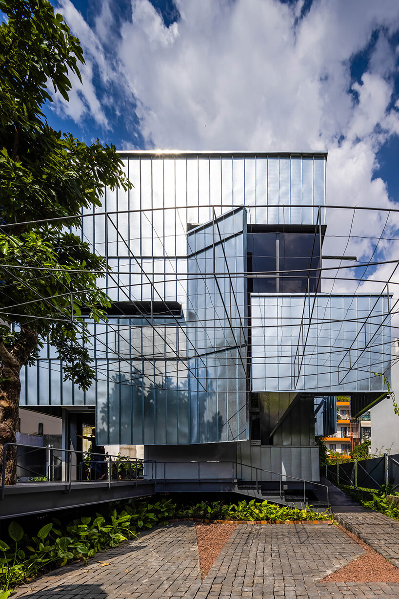 seemingly built from scraps, aaaaaa's office on stilts embraces the vietnamese climate