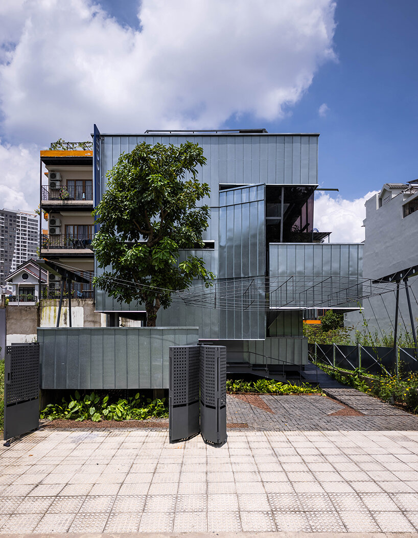 seemingly built from scraps, aaaaaa's office on stilts embraces the vietnamese climate