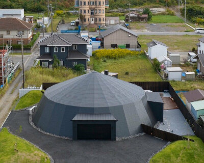 humans and cars cohabitate in this playful retreat shaped like a circus tent in japan 