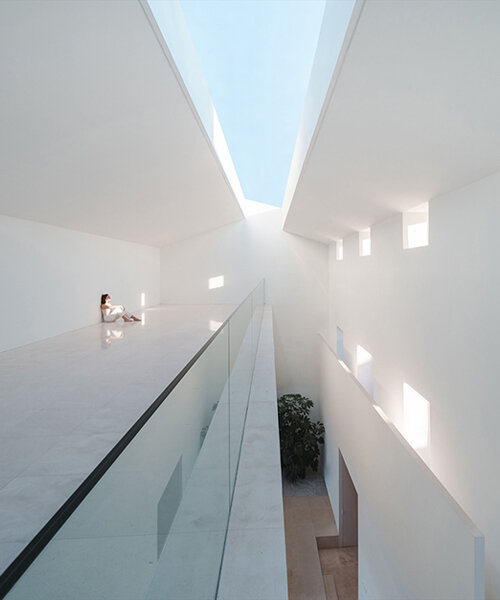 fran silvestre arquitectos enlivens 20th-century house in spain with triple-height interiors
