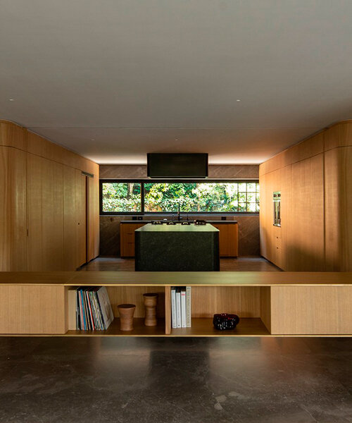 oak wood skin curves the edges of loma apartment in mexico