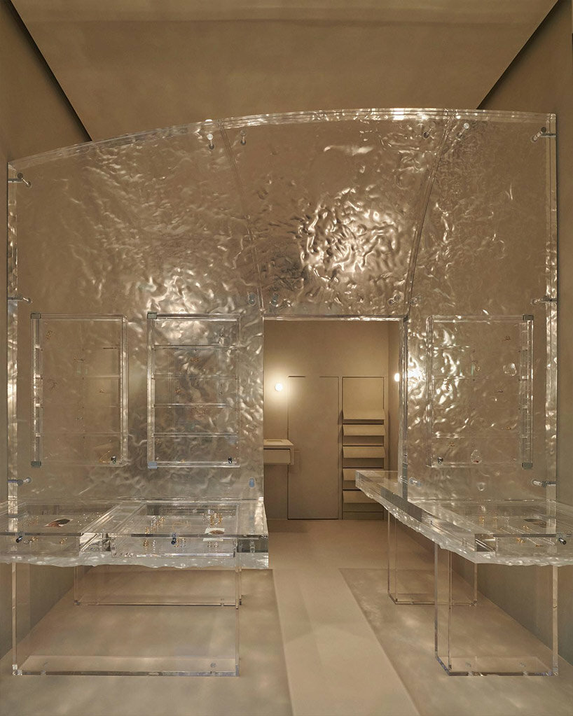 fine jewelry collection floats within monolithic translucent wall in ...