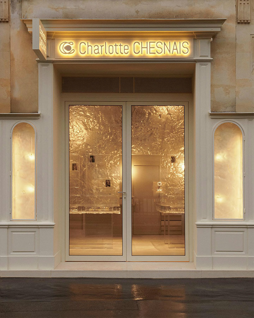 fine jewelry collection floats within monolithic translucent wall in parisian boutique