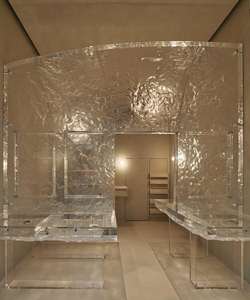 anne holtrop nestles jewelry series within monolithic translucent wall in parisian boutique