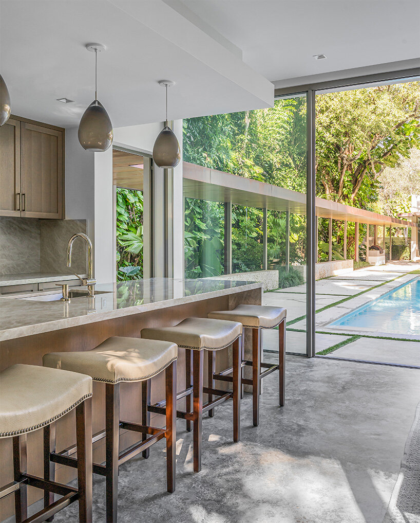upstairs studio architecture's poolside pavilion nestled in miami backyard