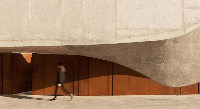 undulating concrete entrance adorns calujac architecture's family house in rural moldova