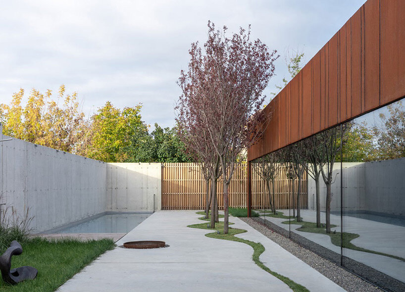 undulating concrete entrance adorns calujac architecture's family house in rural moldova