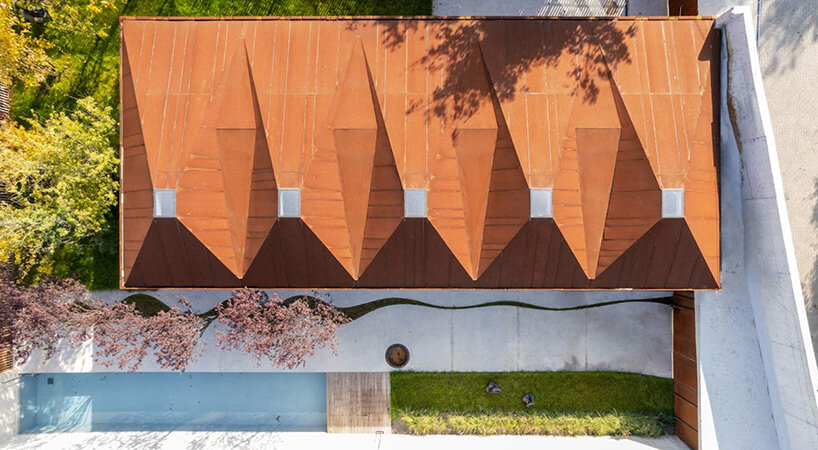 undulating concrete entrance adorns calujac architecture's family house in rural moldova