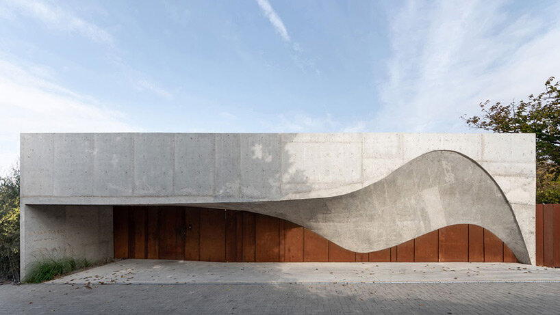 The curved concrete entrance adorns Calujac Architecture's family home in rural Moldova