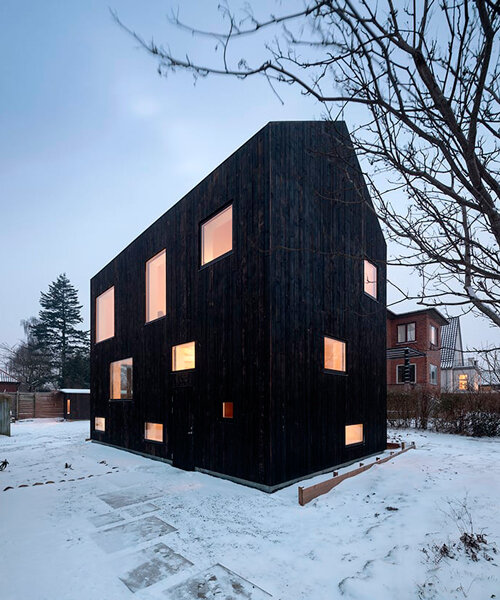 burnt timber composes barn-shaped villa by nord architects in copenhagen