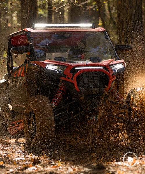 multi-terrain off-roader polaris RZR XP weathers steep hills, rough bumps, and muddy paths
