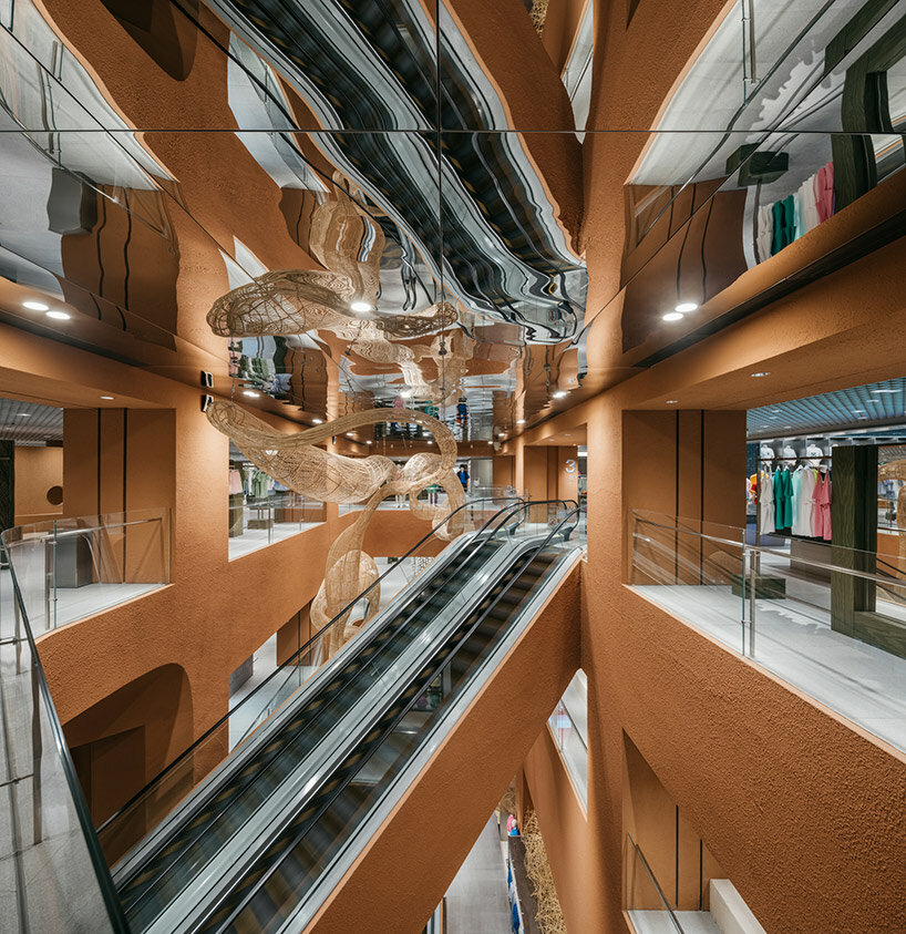 woven bamboo installation by AIM architecture drapes over fashion store atrium in china