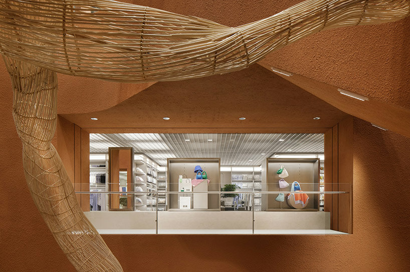 woven bamboo installation by AIM architecture drapes over fashion store atrium in china