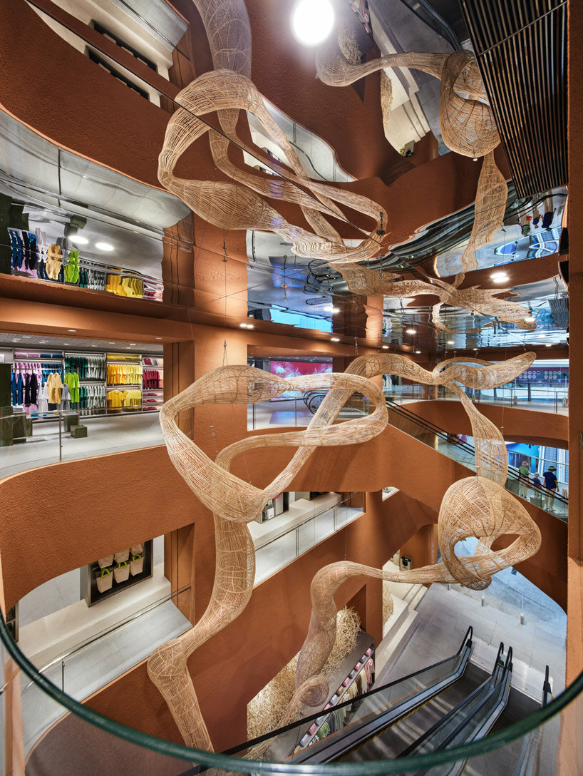 woven bamboo installation by AIM architecture drapes over fashion store atrium in china