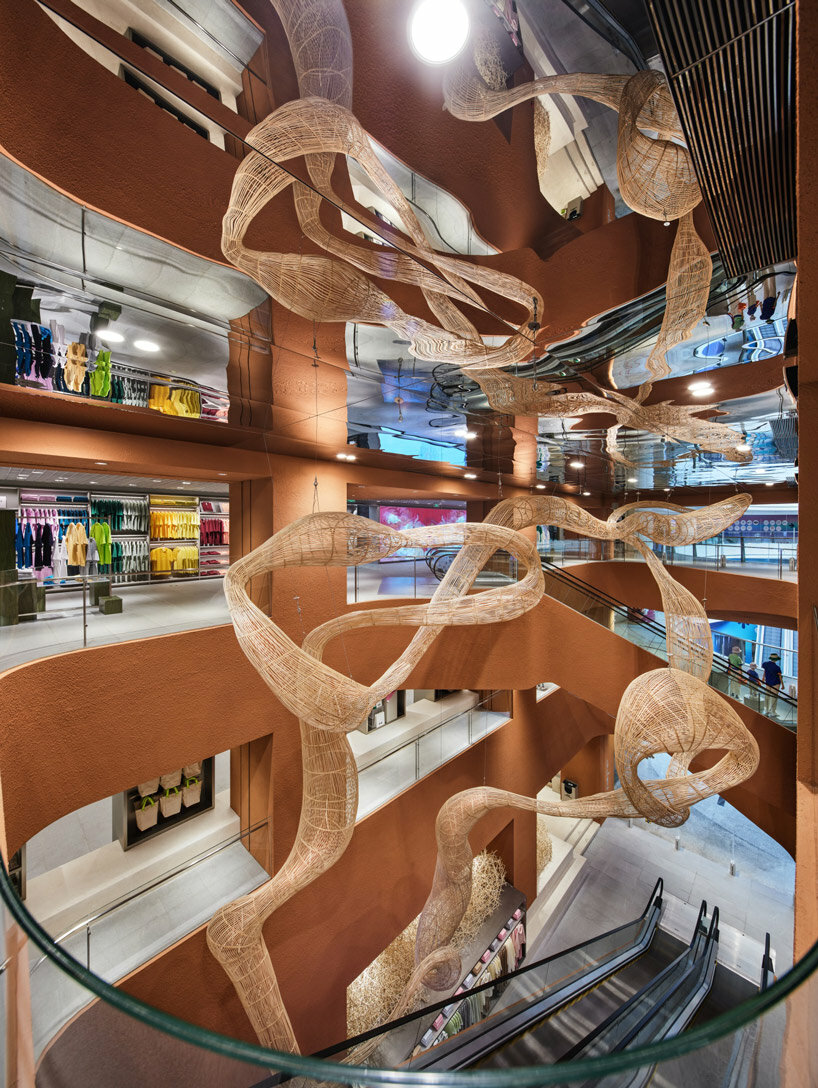 woven bamboo installation by AIM architecture drapes over fashion