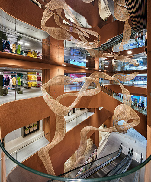 woven bamboo installation by AIM architecture drapes over fashion store atrium in china
