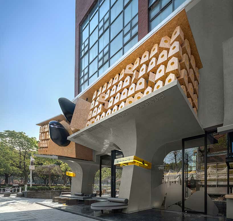 wooden roost boxes nestle on monumental columns for 'chic chic bird' noodle shop in china