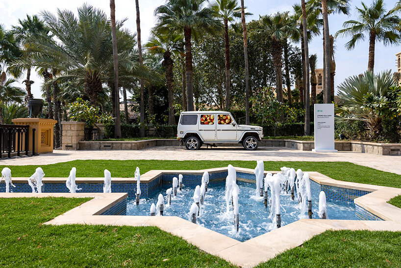 julien boudet rests giant counterfeit basketball on top of mercedes G wagon at art dubai