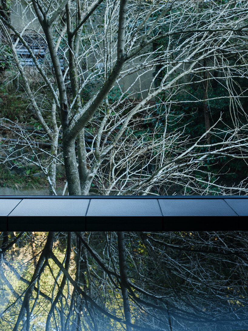 kubo tsushima architects reflects river onto mirrored hotel-spa ceiling in japan