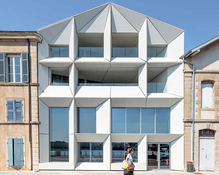 recessed angular frames form art house cinema's facade in france
