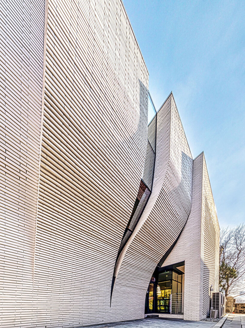 a curved brick wall ripples across LESS architects' office building design in seoul