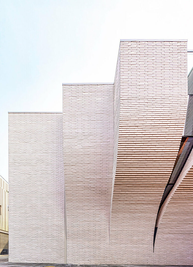 a curved brick wall ripples across LESS architects' office building ...