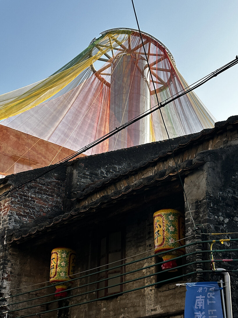 MAD architects wraps abandoned chinese landmark in ethereal veil of multicolored cloth