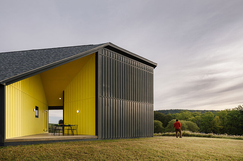 a striking yellow void punctuates scalar architecture's farm-like residence in the berkshires