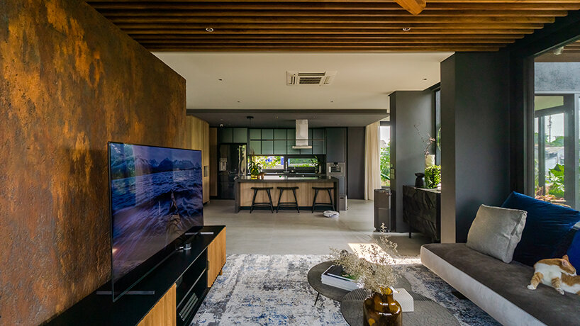 grass, stones, shrubs, and trees envelop studioRK's vibrant OHIO house in indonesia